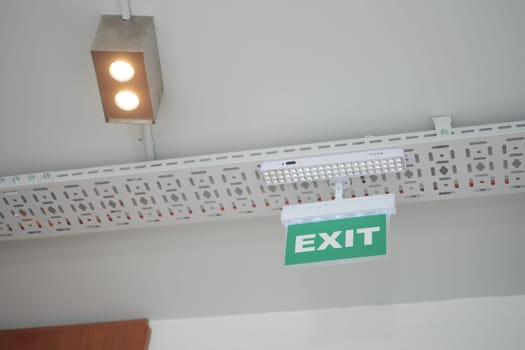 Green exit sign displayed above in a well-lit building area.