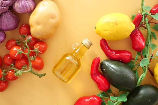 Colorful vegetables, including tomatoes, peppers, and lemon, displayed with oil.