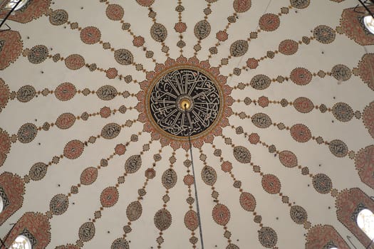 Visitors admire the stunning ceiling decorated with detailed patterns.
