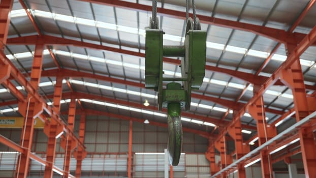 Closeup of swivel chain hook crane of electric hoist in factory workshop, pullersSwivel chain hook equipment for pullers, industry lifting machine