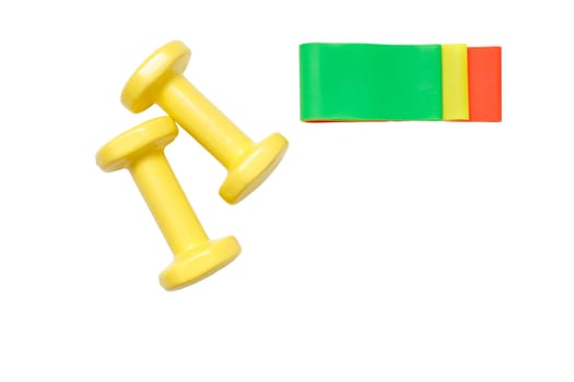 Yellow dumbbells and set of fitness rubber bands isolated on white background. View from above.Top view. Copy space