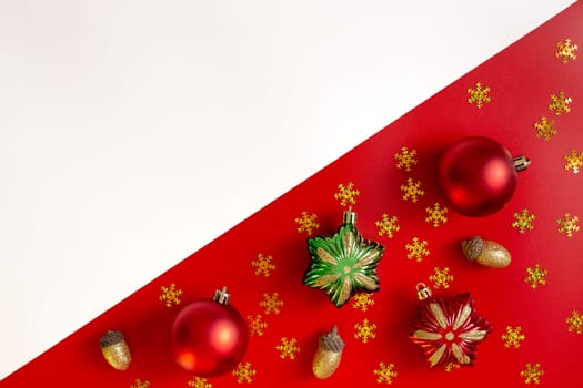 Diagonally red and white background of Christmas decorations, and colored toys. Copy space.