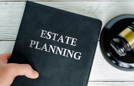 Top view of Estate Planning book with gavel background.