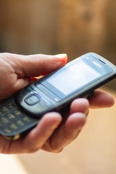 Belarus, Minsk - 09.03.2025: A person is holding a classic Nokia cell phone in their hand, showcasing its design and functionality as a reliable communication tool
