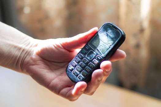 Belarus, Minsk - 09.03.2025: A person is currently holding an older model flip phone, which clearly has the brand name Samsung displayed on its exterior surface