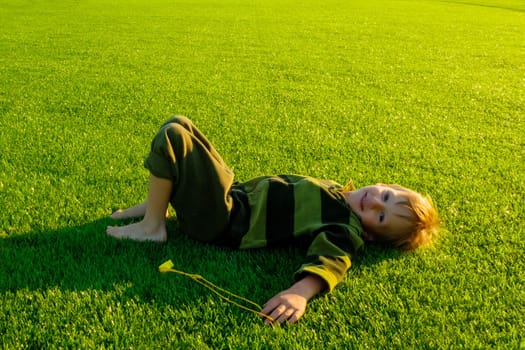 The child goes in for sports at the stadium. The boy training before playing football. High quality photo