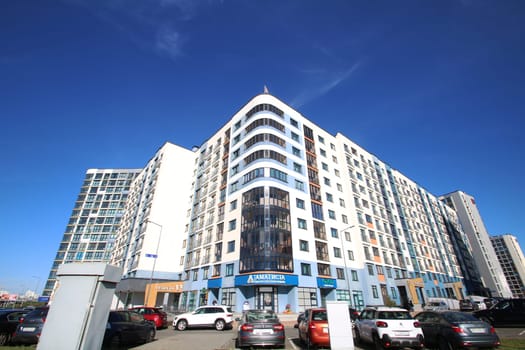 Belarus, Minsk - 04, 01,2025:In a bustling city environment, there stands a large white building that prominently features a blue sign displaying the brand name abercrombie fitch on it