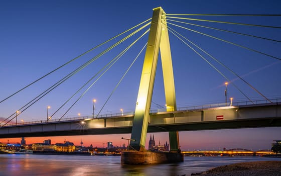 Cologne, Germany - September 18, 2024: Severin bridge and cathedral of Cologne against sunset on September 18, 2024 in Germany, Europe