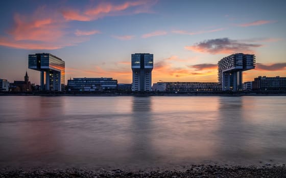 Cologne, Germany - September 18, 2024: Panoramic image of modern buildings in the harbor of Cologne during nightbreak on September 18, 2024 in Germany, Europe
