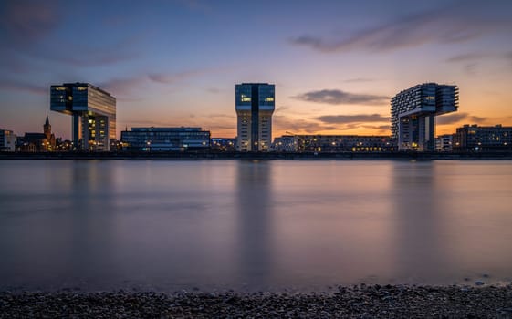 Cologne, Germany - September 18, 2024: Panoramic image of modern buildings in the harbor of Cologne during nightbreak on September 18, 2024 in Germany, Europe
