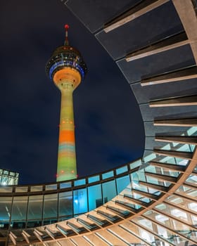 DUSSELDORF, GERMANY - MARCH 25, 2023: Illuminated Rhine Tower and state parliament of North Rhine Westphalia on March 25, 2023 in Dusseldorf, Germany, Europe