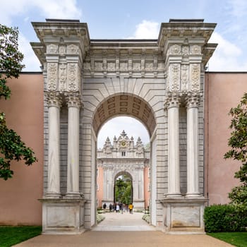 Istanbul, Turkey - May 10, 2023: Entrance of Dolmabahce Palace, with tourists visiting the place - View from the inner courtyard