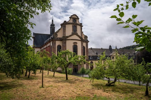 Himmerod, Germany - July 26, 2024: Panoramic image of monastery church Himmerod in morning light on July 26, 2024 in Rhineland-Palatinate, Germany