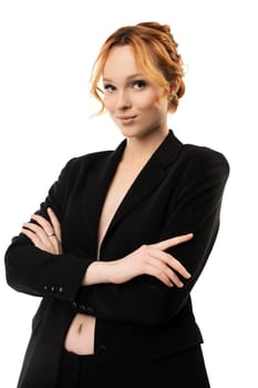 portrait of a sexy redhead businesswoman posing in black suit isolated