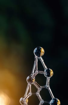A glass molecular structure model, resembling a crystalline lattice, artfully captures light, creating a captivating visual representation of atomic bonds.