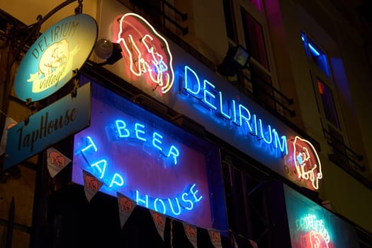 Brussels, Belgium: March 14 2024 - Delirium Village Tap House bar entrance. The place name comes from the beer Delirium Tremens produced by the Huyghe family brewery.