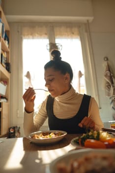 A woman joyfully savoring a scrumptious and delicious meal in a sunlit, cheerful room, highlighting healthy eating
