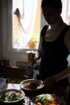A woman plating a delicious dish, displaying her cooking artistry in a warm kitchen filled with fresh ingredients