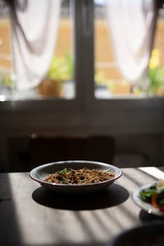 A closeup photo of delicious noodles, beautifully lit by warm sunlight, creating a cozy atmosphere