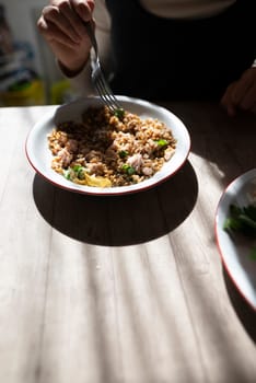 A vibrant bowl of homemade food on a wooden table, showcasing delicious ingredients and cozy ambiance.