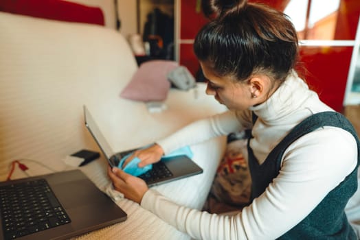 A person multitasks efficiently with laptops, demonstrating remote work and available technology tools
