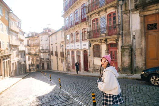 A beautifully sunny street located in a historic city, characterized by its charming cobblestones and vibrant buildings