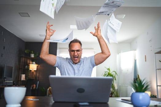 Frustrated middle aged Caucasian man working at home.