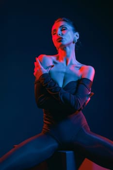 Glamorous woman in dramatic lighting posing in bodysuit, expressing confidence and sensual elegance in studio.