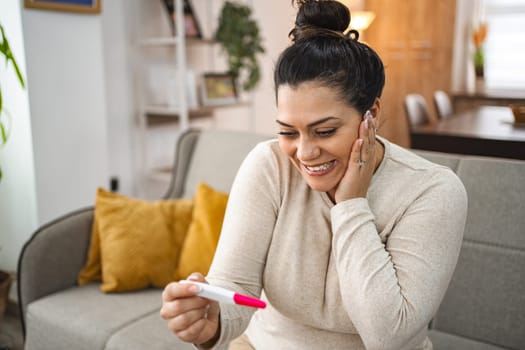 Woman feeling excited after doing a pregnancy test.