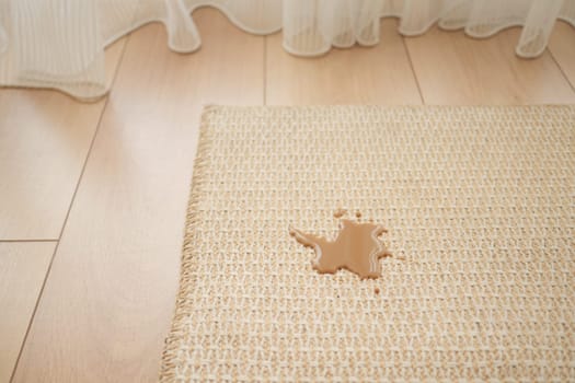 Melted chocolate oozes onto a woven mat in a bright room.