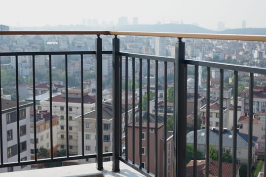 A panoramic view highlights a vibrant city from an elevated balcony.