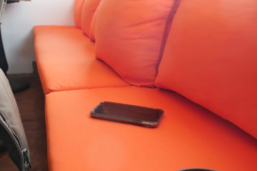 lost smart phone concept. smart phone left on a sofa ,