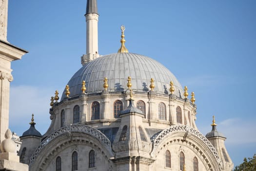 The ornate dome of an ancient mosque sparkles in the sunlight.