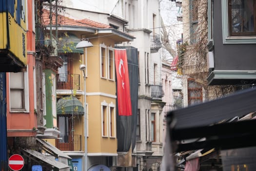 A lively urban street in Istanbul adorned with a Turkish flag.