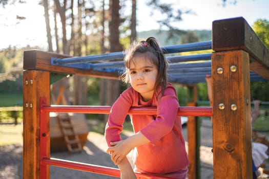 Active cute little girl on the playground.
