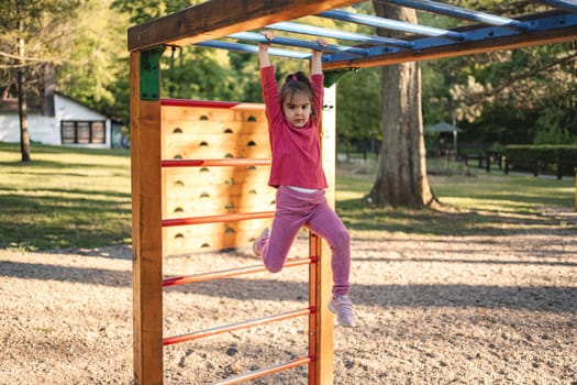 Active cute little girl on the playground.