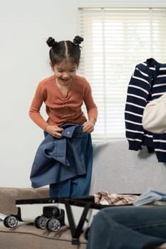 Capturing the enthusiasm of a child helping to pack, this image highlights family interaction and the delight that comes with preparing for a getaway.