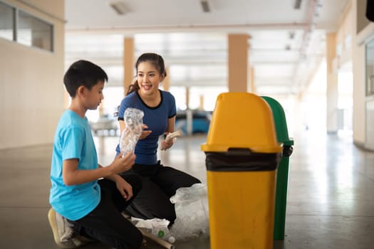 A young boy receives guidance from an adult on how to properly dispose of materials, reinforcing community engagement in recycling efforts.