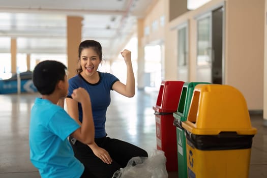 A child joyfully celebrates after learning about recycling, showcasing the positive reinforcement of sustainable practices by a caregiver.