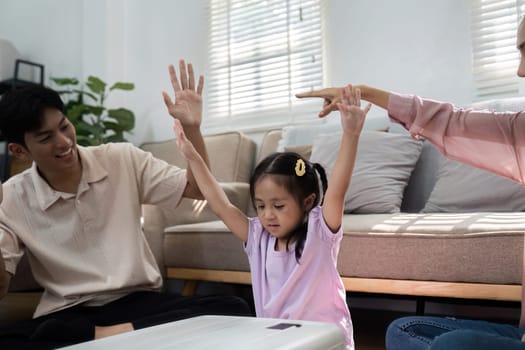 The daughter celebrates with her hands raised as her parents cheer, highlighting the joyous anticipation of family travels and shared moments of connection.