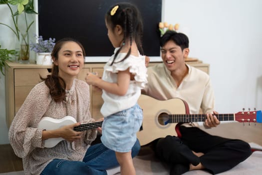 The family enjoys a vibrant music session, showcasing their love and connection as they play instruments and share joyful experiences together.