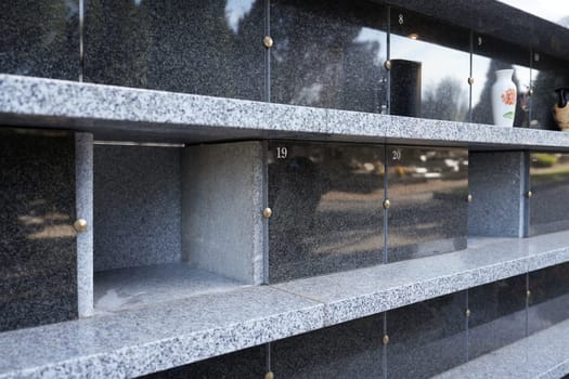 Family columbarium for burial of urns with ashes or coffins European cemetery with graves
