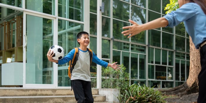 After an exciting school day, a boy joyfully runs to his mother, who welcomes him with open arms. This moment captures the essence of family joy and connection.