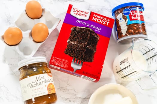 Denver, Colorado, USA-September 7, 2023-Gathered on the kitchen counter are the essential ingredients needed to create irresistible chocolate cupcakes, using a convenient cake mix and luscious chocolate frosting.