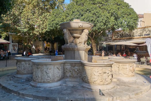 Crete.Greece - april 07, 2025: Ornate Renaissance-era fountain adorned with symbolic lion statues, standing as a serene centerpiece amidst Heraklion’s dynamic urban life and cultural charm.