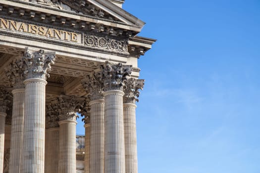 Paris, France - February 22, 2025: A view of the Pantheon under a blue sky, showcasing its classical columns and intricate architectural details