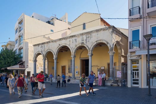 Crete, Greece - April 7, 2025: A charming restaurant in Heraklion featuring outdoor seating, vibrant Mediterranean decor, and a menu showcasing authentic Cretan cuisine in a lively urban setting.