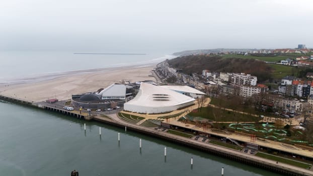 Boulogne. France 03.28.2025 Aerial view of a striking modern building by the beach in Boulogne-sur-Mer, France, with seaside promenade and residential area.