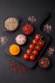 Red cherry tomatoes on a branch, a spiced vegetable as an ingredient for making sauces and ketchup