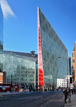 London, United Kingdom - February 02, 2019: Vauxhall bridge road, red buses on sides, with tall Nova Building at the end - modern glass and steel architecture designed by Benson + Forsyth, 